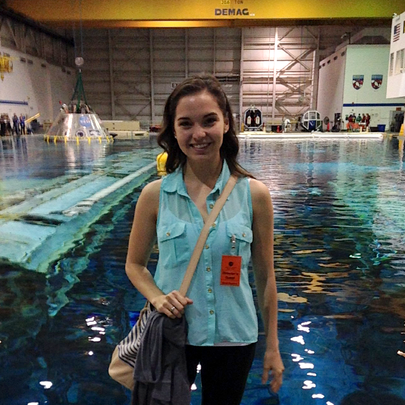 Student smiling in front of pool